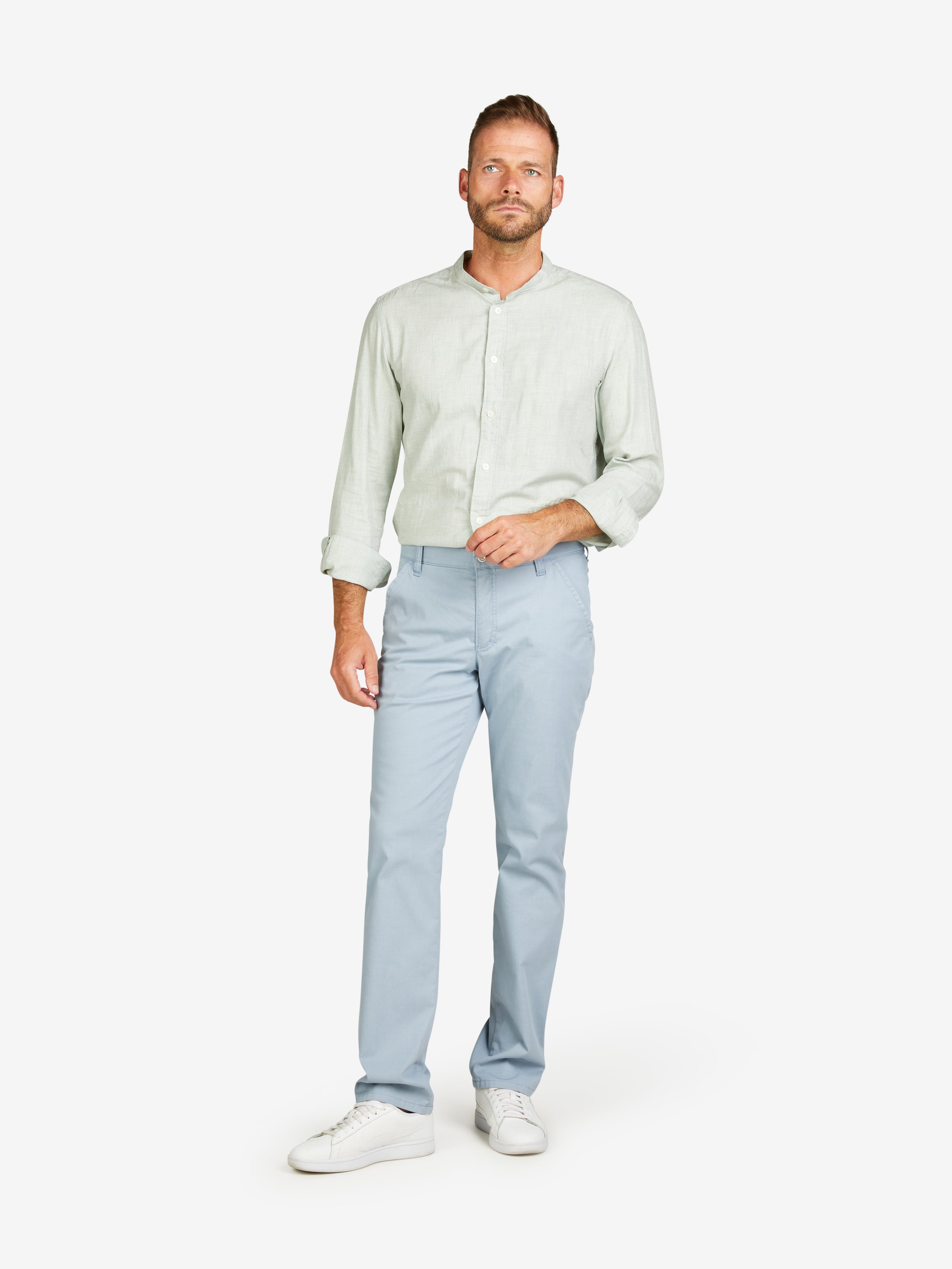 Mann trägt eine hellblaue GARVEY 8124 Flat Front-Hose mit elastischem Komfortbund, Hemdstopper und Münztasche. Die Hose besteht aus hoch elastischer Baumwoll-Mikrostruktur mit Coolmax® EcoMade Klimaregulierung, normaler Leibhöhe, schmalem Bein und ist langlebig und umweltfreundlich.