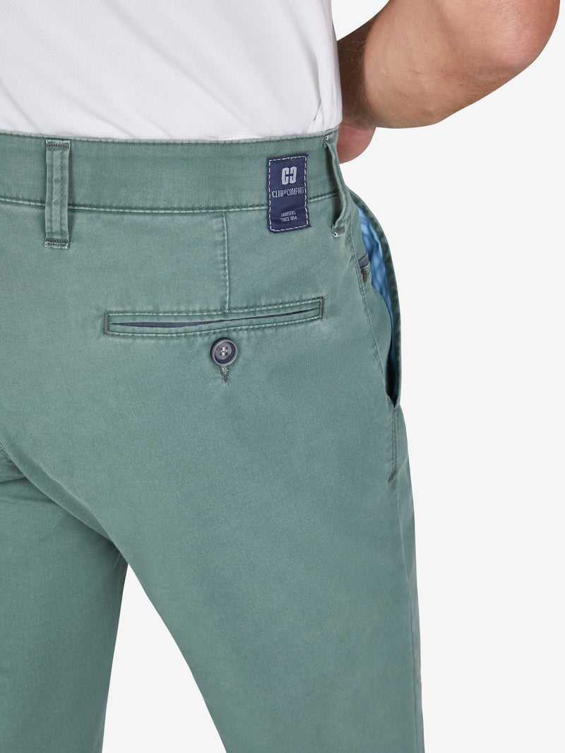 Nahe.Bild eines Mannes trägt eine blau-grüne Flat Front-Hose mit elastischem Komfortbund, Hemdstopper und Münztasche. Die Hose besteht aus leichtem, recyceltem Baumwoll-High Stretch mit Coolmax EcoMade Faser, reguliert die Temperatur, hat eine schmale Fußweite und eine normale Leibhöhe.